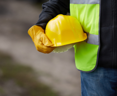 Hard hat being held for safety on the job