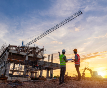 Two men prepping crane rigging